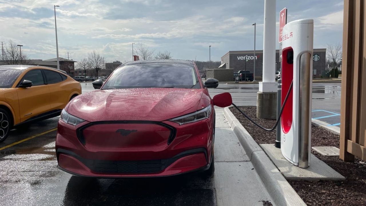 Ford car at fuel station on road near two car