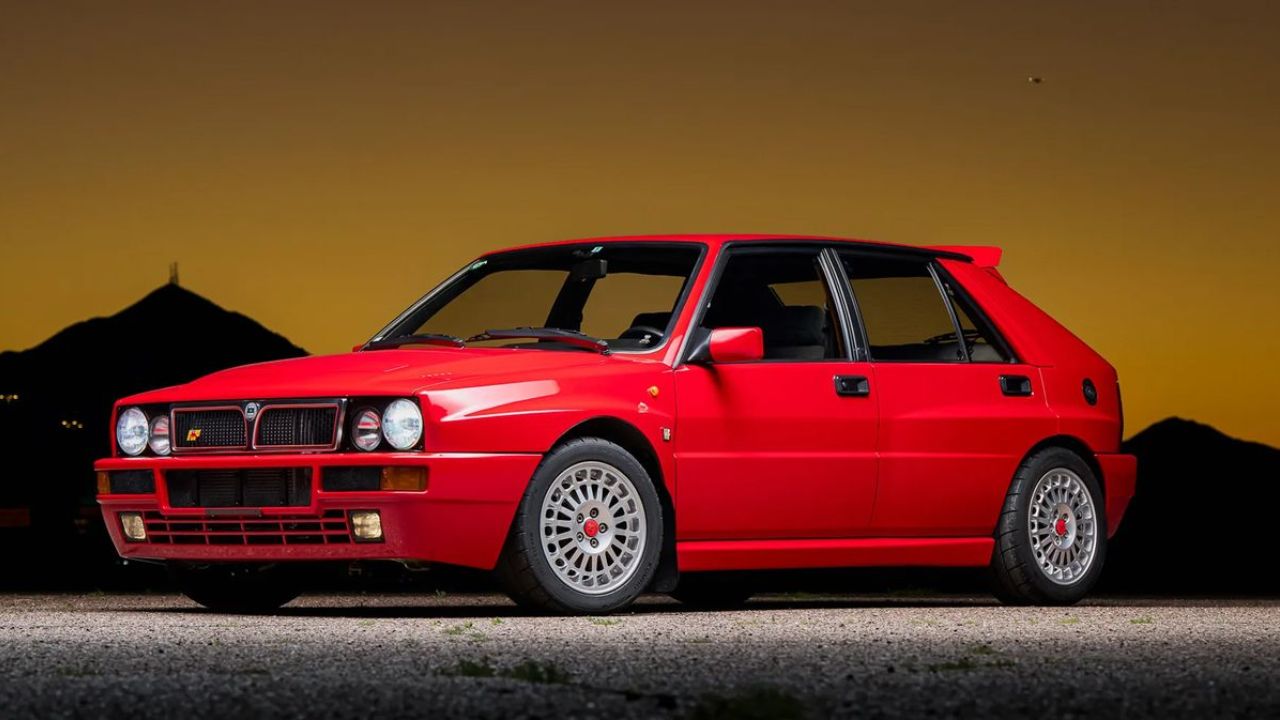 Lancia Delta Integrale in red color in evening in front of mountains